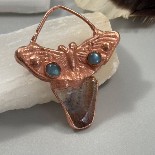 Handmade copper butterfly adorned with labradorite crystals and a super seven crystal necklace