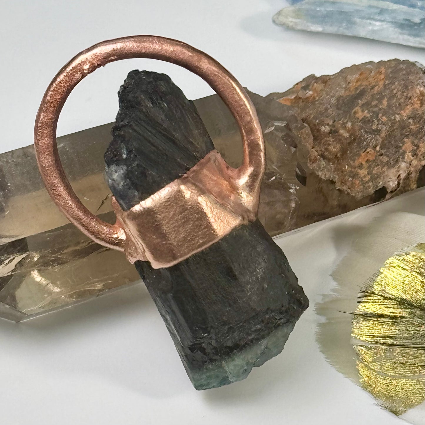 A handmade crystal pendant with copper and tourmaline 