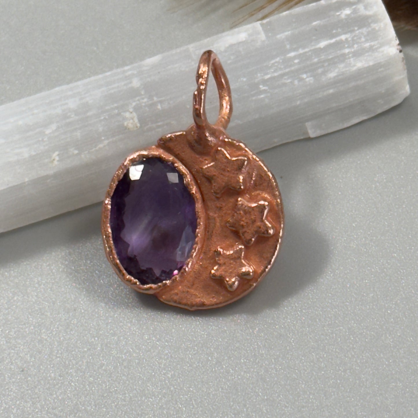Faceted purple amethyst crystal with a copper moon necklace