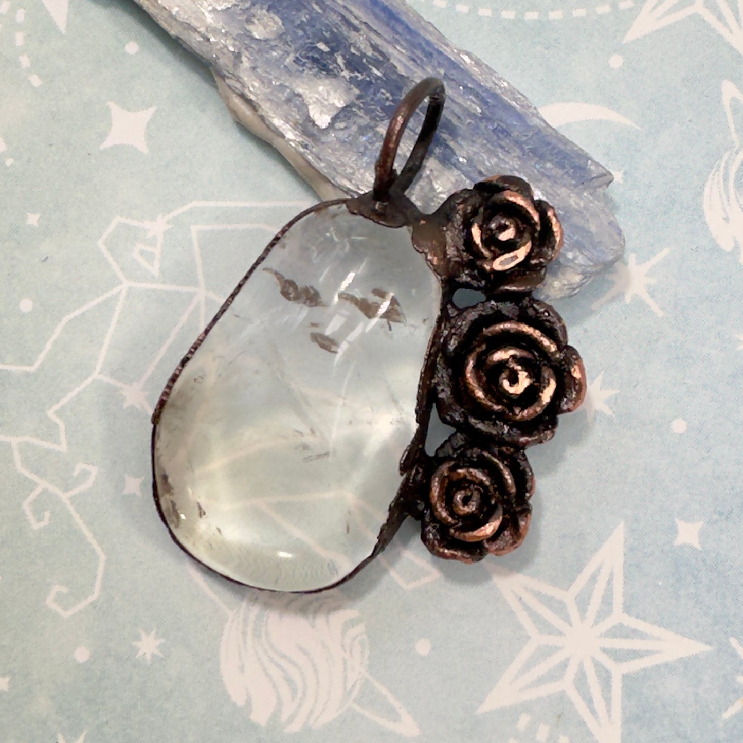 Copper roses surrounding a healing clear quartz crystal necklace 
