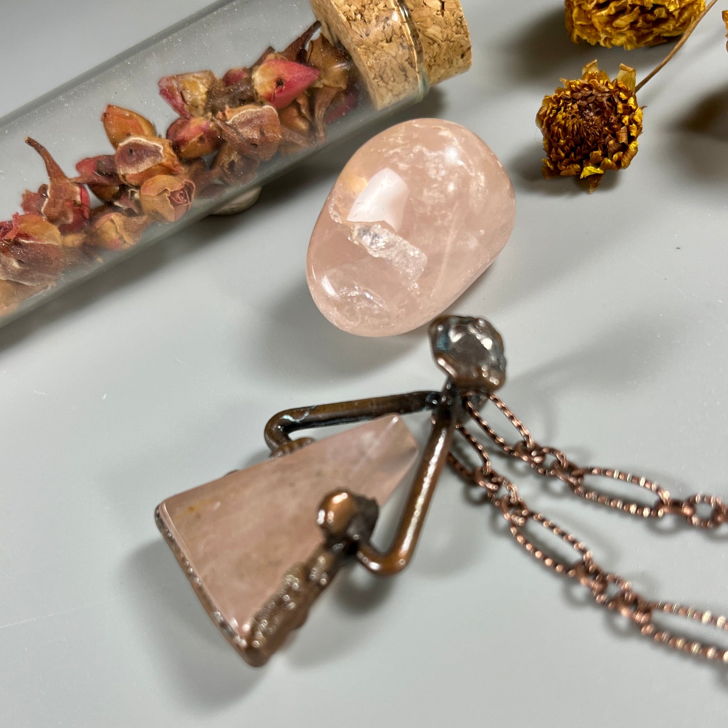 side view of rose quartz necklace, handmade and copper electroformed.