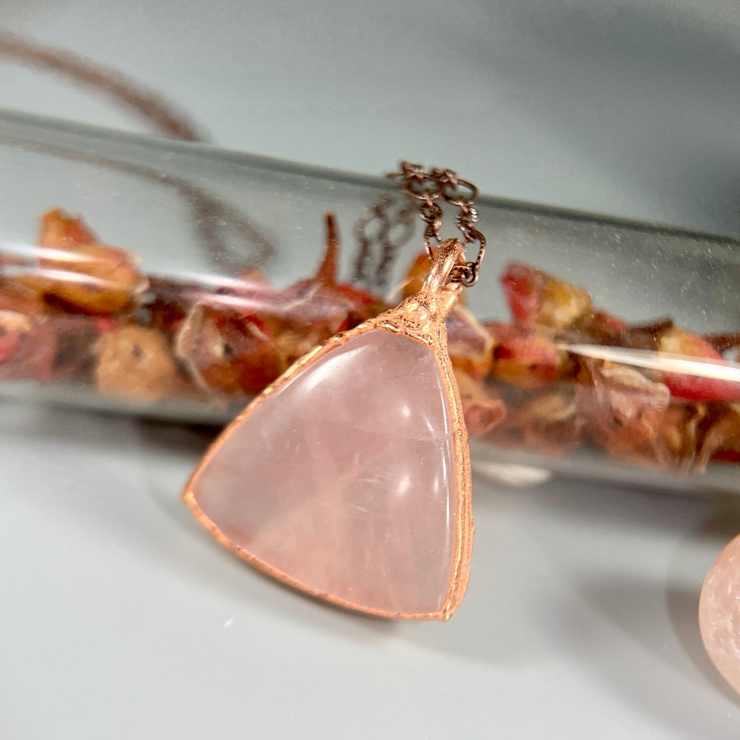 beautiful rose quartz crystal in a two inch smooth shaped triangle.